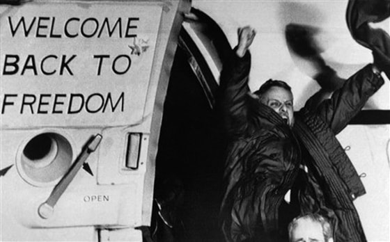 In this Jan. 21, 1981 file photo, freed U.S. hostage David Roeder shouts and waves as he arrives at Rhein-Main U.S. Air Force base in Frankfurt, Germany. Roeder was among 52 Americans held hostage in Iran for 444 days after their capture at the U.S. Embassy in Tehran.